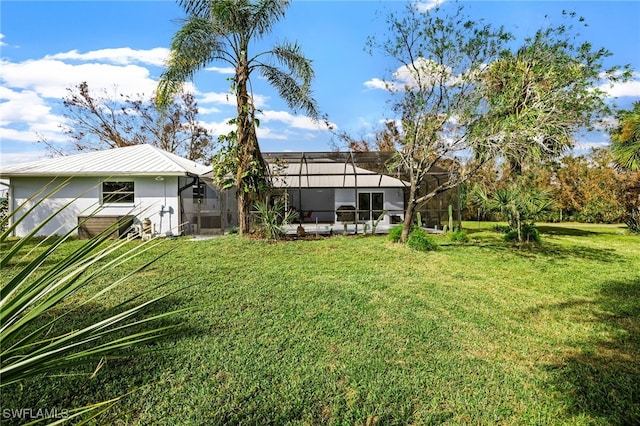 exterior space with a yard and a lanai