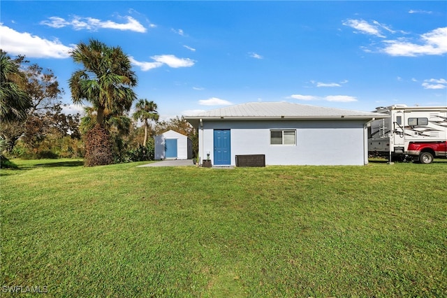 rear view of property with a yard