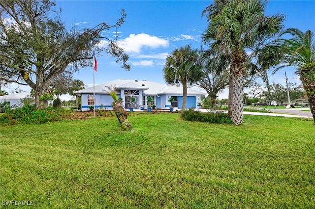 view of front facade with a front yard and a garage