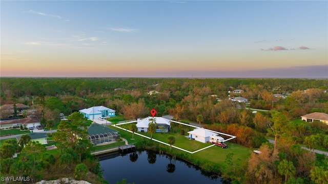 aerial view at dusk with a water view