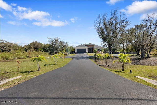 view of front facade with a front yard and a garage