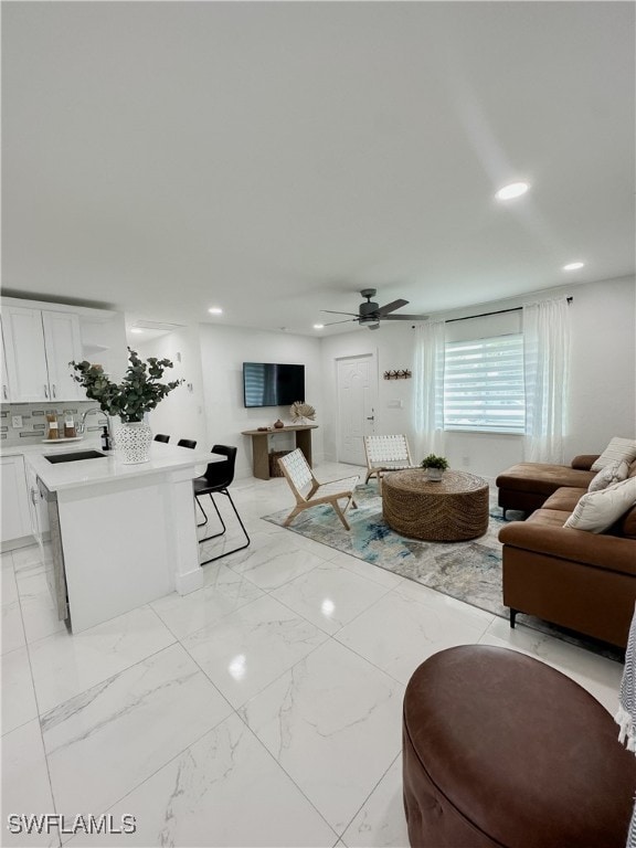 living room with sink and ceiling fan