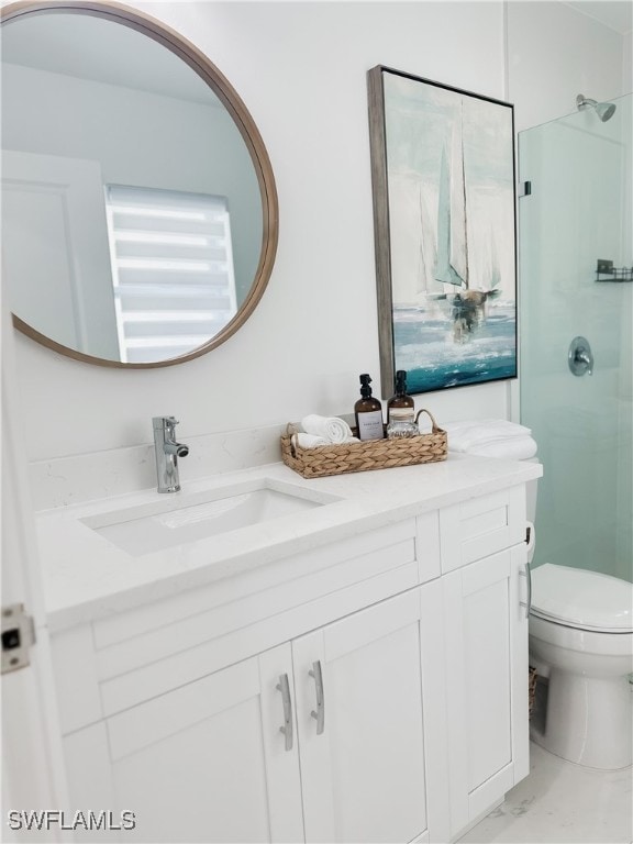 bathroom with vanity, toilet, and a shower with shower door