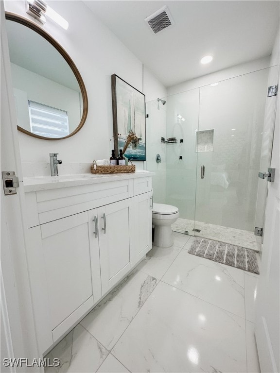 bathroom featuring vanity, toilet, and walk in shower