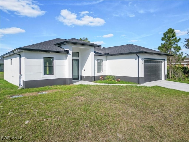 prairie-style house with an attached garage, a front lawn, concrete driveway, and stucco siding