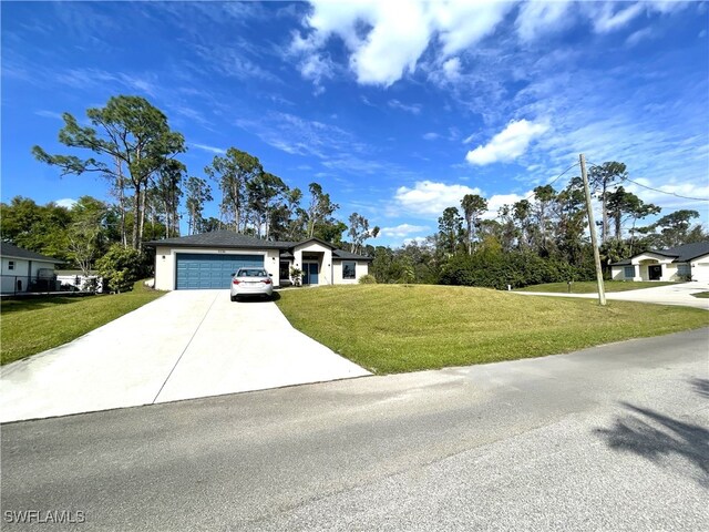 view of front of property with a front lawn and a garage