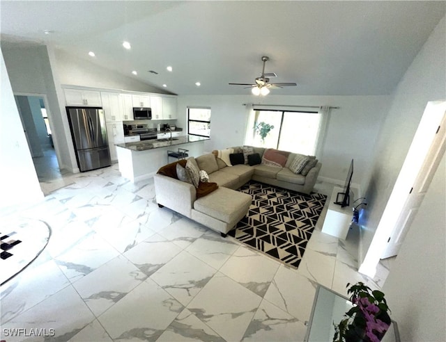 living room with lofted ceiling, sink, and ceiling fan