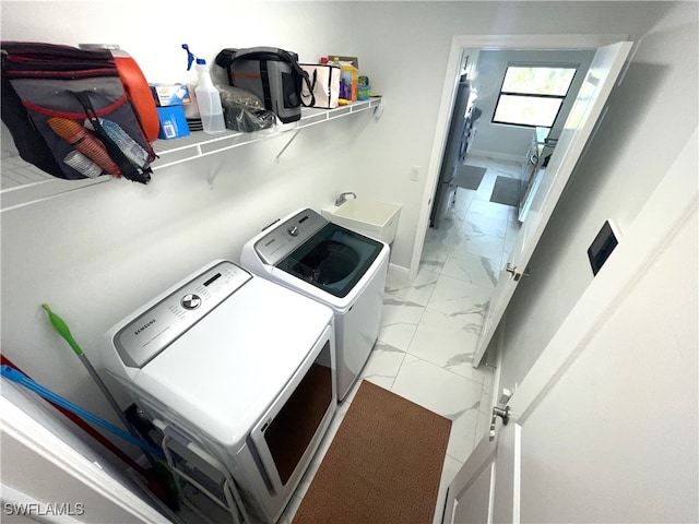 laundry area featuring sink and washer and clothes dryer