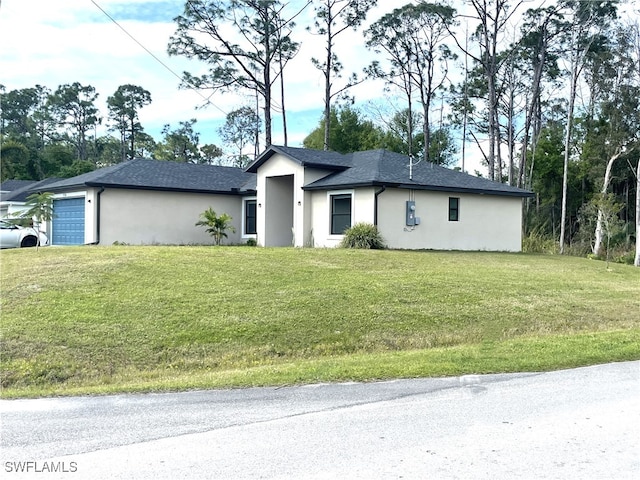 view of front of home with a front lawn and a garage