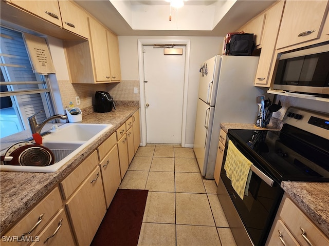 kitchen featuring backsplash, stainless steel appliances, sink, light brown cabinets, and light tile patterned floors