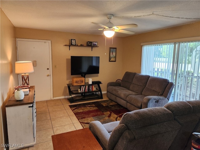 tiled living room with ceiling fan and a textured ceiling