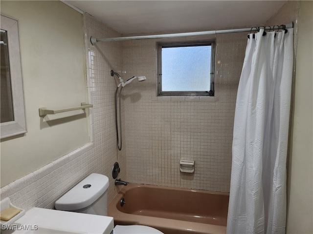 bathroom featuring toilet and shower / bath combo with shower curtain