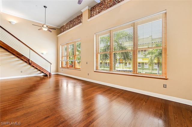 2260 First St Unit 207, Fort Myers, FL 33901 - unfurnished living room with ceiling fan, baseboards, hardwood / wood-style floors, and crown molding