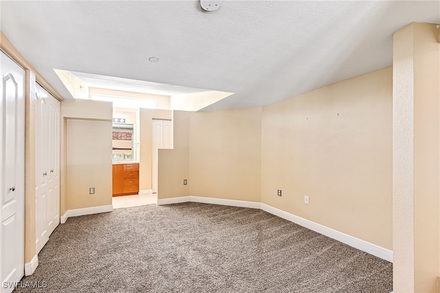 unfurnished bedroom featuring a textured ceiling and carpet floors