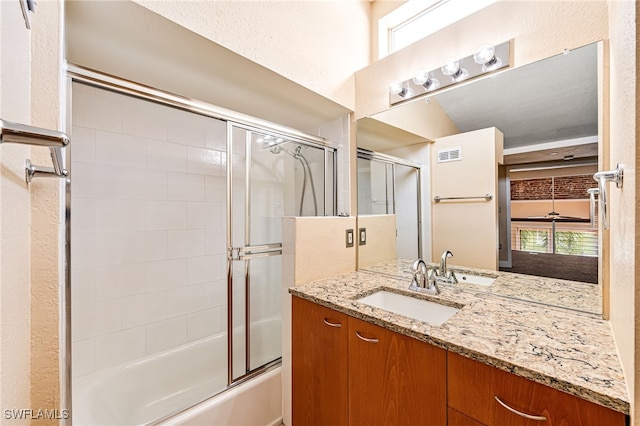 bathroom featuring vanity and enclosed tub / shower combo