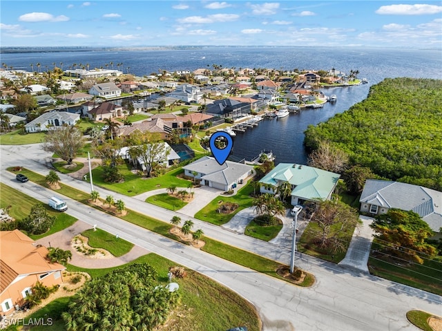 drone / aerial view featuring a water view and a residential view