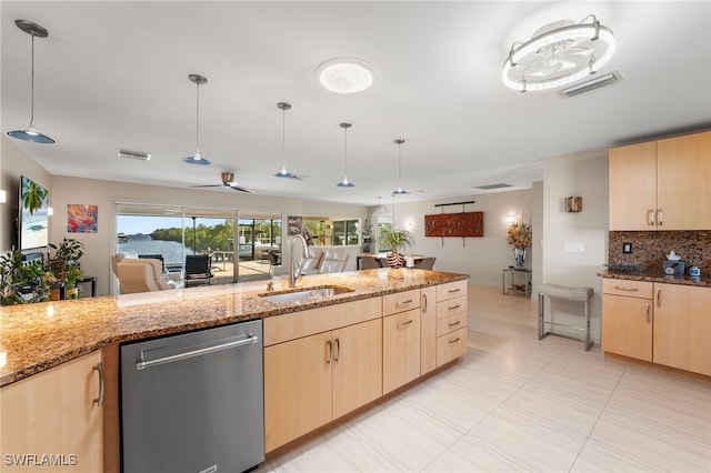 kitchen with light brown cabinets, a sink, and stainless steel dishwasher