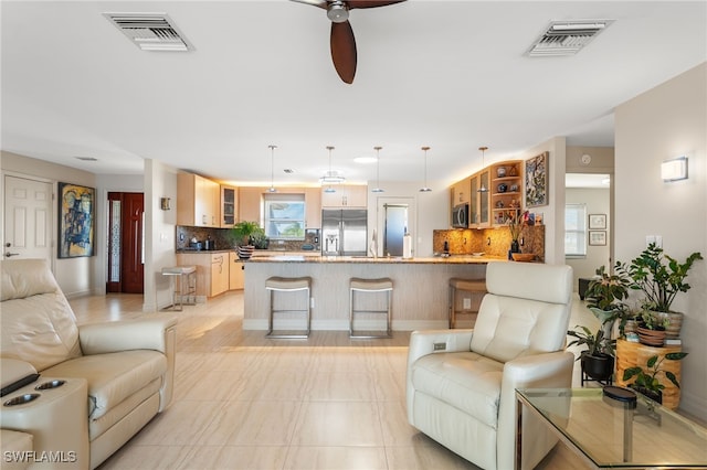 living room with visible vents and a ceiling fan