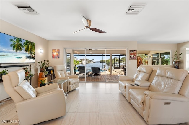 living area featuring ceiling fan and visible vents