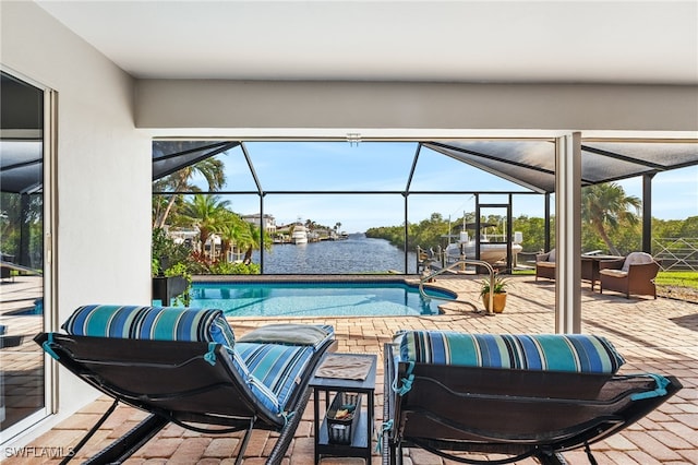 outdoor pool featuring a patio, a water view, and a lanai