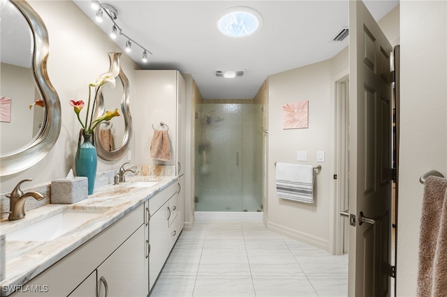 bathroom with tile patterned flooring, vanity, and a shower with shower door