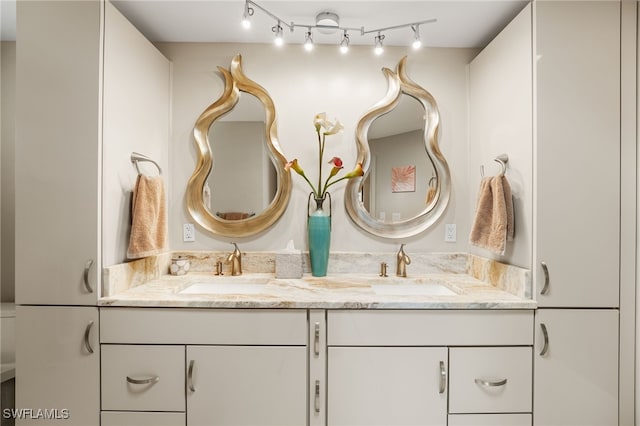 bathroom with a sink and double vanity