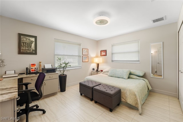 bedroom with baseboards and visible vents