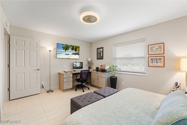 bedroom with baseboards and light tile patterned floors