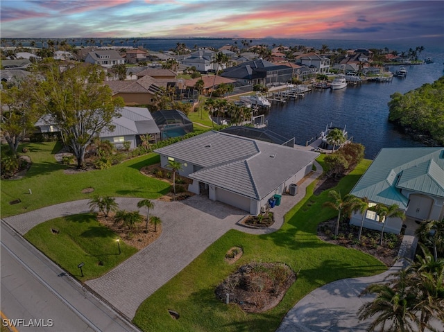 aerial view at dusk with a water view