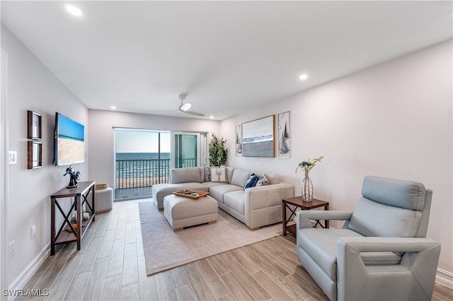 living room featuring ceiling fan and light hardwood / wood-style floors