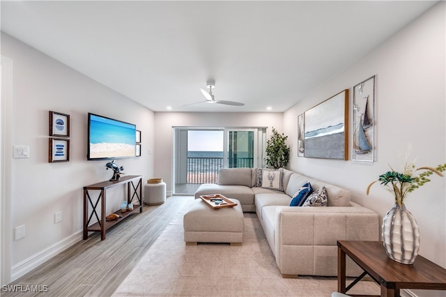 living room with ceiling fan and light hardwood / wood-style floors