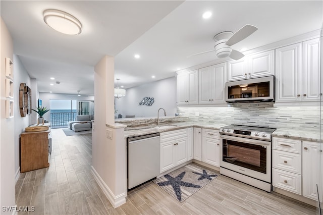 kitchen featuring white cabinetry, sink, ceiling fan, light hardwood / wood-style floors, and appliances with stainless steel finishes