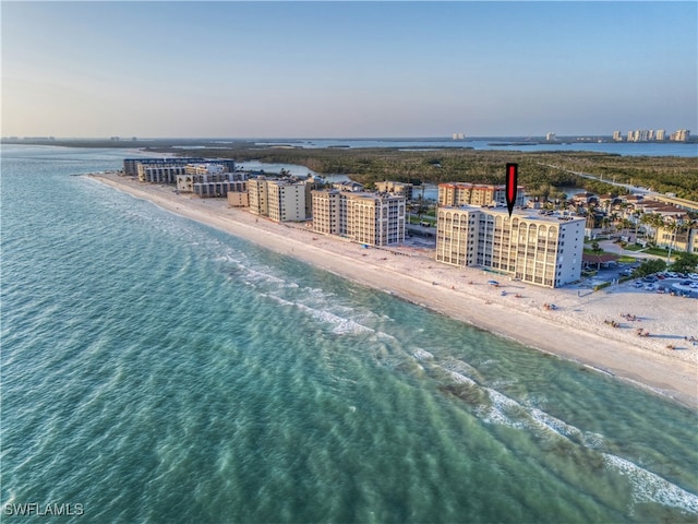 birds eye view of property featuring a view of the beach and a water view