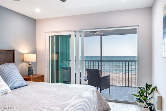 bedroom with access to outside, a water view, and light hardwood / wood-style floors