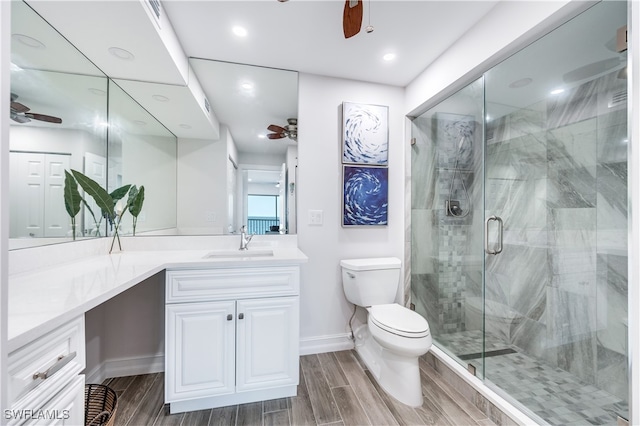 bathroom featuring hardwood / wood-style floors, vanity, toilet, and an enclosed shower