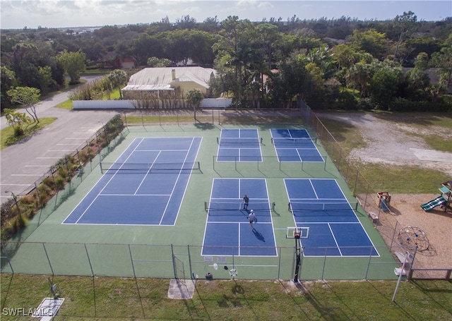 view of tennis court featuring a playground