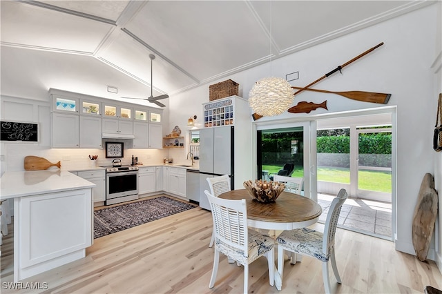 interior space featuring lofted ceiling, sink, and light wood-type flooring