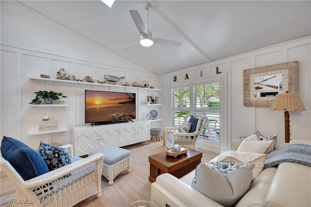 living room featuring light hardwood / wood-style floors, lofted ceiling, and ceiling fan