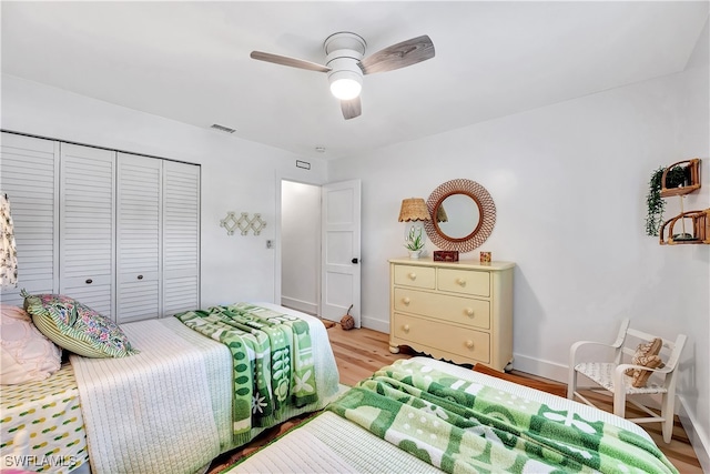 bedroom with a closet, ceiling fan, and light hardwood / wood-style flooring