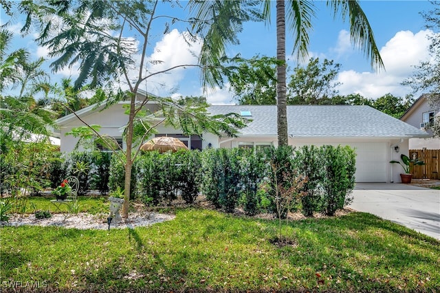 view of front of house with a front lawn and a garage