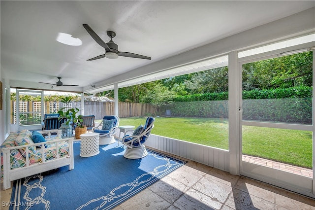 sunroom featuring ceiling fan