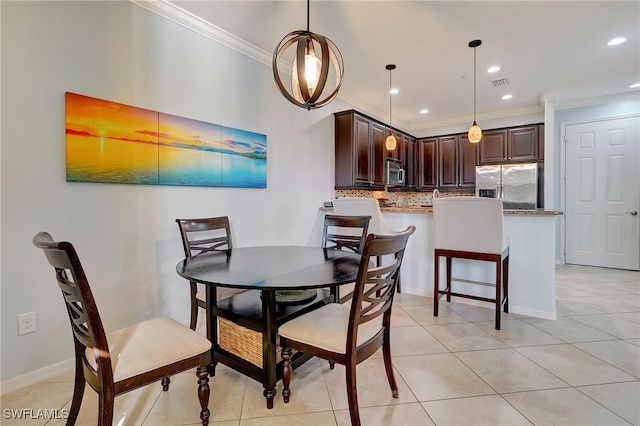 dining area featuring light tile patterned flooring and ornamental molding