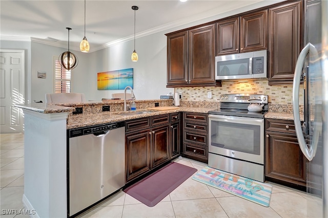 kitchen with dark brown cabinets, pendant lighting, appliances with stainless steel finishes, and kitchen peninsula