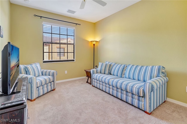 carpeted living room featuring ceiling fan