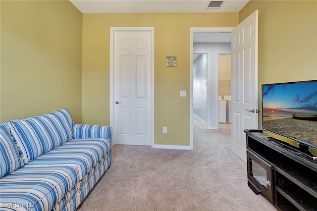 carpeted living room featuring washer / clothes dryer