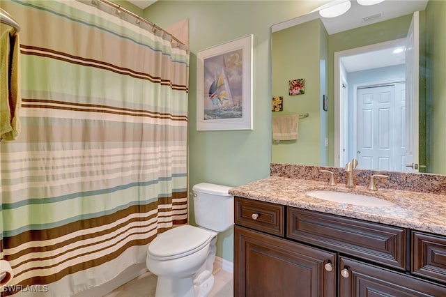 bathroom with toilet, vanity, and a shower with shower curtain