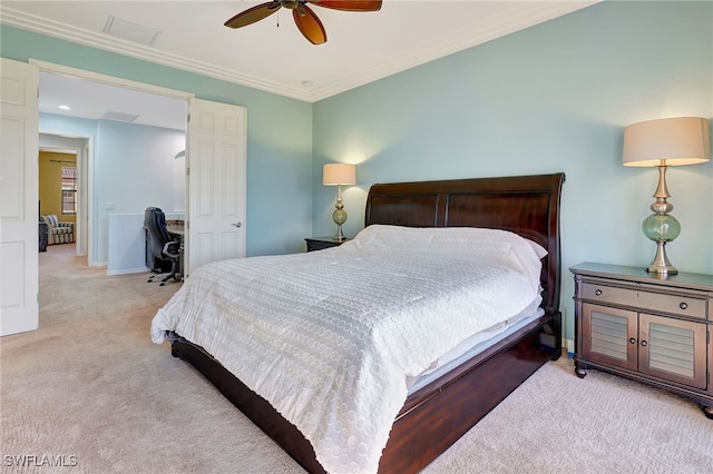 carpeted bedroom featuring ceiling fan and crown molding