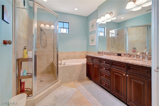 bathroom with independent shower and bath, tile patterned flooring, and vanity