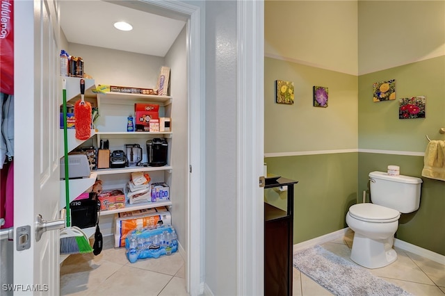 bathroom featuring toilet and tile patterned flooring