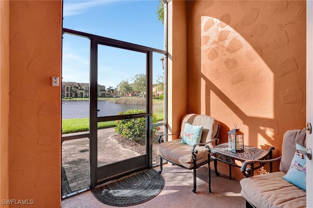 entryway featuring a water view and carpet flooring